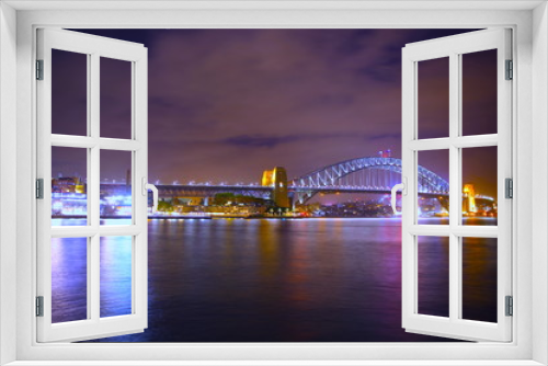 Fototapeta Naklejka Na Ścianę Okno 3D - Sydney Harbour Bridge illuminating the harbour and circular quay with vibrant colourful lights at midnight in NSW Australia
