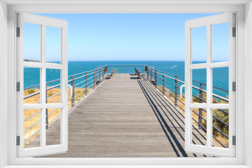 Fototapeta Naklejka Na Ścianę Okno 3D - Benches on the terrace at the ocean in Albufeira