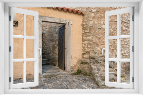 Fototapeta Naklejka Na Ścianę Okno 3D - Deteriorated house facade. Rustic doorway in a Spanish town