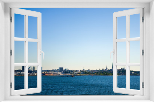 Fototapeta Naklejka Na Ścianę Okno 3D -  View of Old town Tallinn from cruise ship. The calm expanse of the Baltic Sea. In the distance, modern buildings the ancient cathedrals and tower on the coast. Estonia