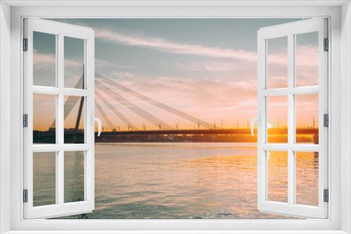 Fototapeta Naklejka Na Ścianę Okno 3D - Riga, Latvia. Vansu Cable-Stayed Bridge Over The Daugava River, Western Dvina In Bright Sunset Or Sunrise Time