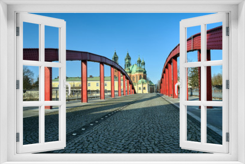 Fototapeta Naklejka Na Ścianę Okno 3D - The steel structure of the bridge and the towers of the Gothic Catholic cathedral in Poznan.