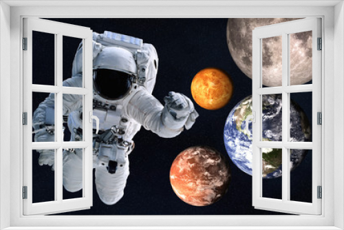 Fototapeta Naklejka Na Ścianę Okno 3D - Astronaut near Planets of solar system together in space. Earth, Mars, Venus, Moon. Science fiction wallpaper. Elements of this image were furnished by NASA.