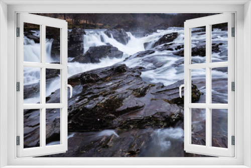 Fototapeta Naklejka Na Ścianę Okno 3D - the waterfalls in Glen Orchy near Bridge of Orchy in the Argyll region of the highlands of Scotland during winter whilst the river is flowing fast from rainfall