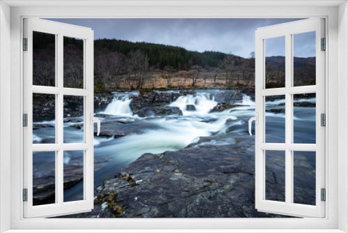 Fototapeta Naklejka Na Ścianę Okno 3D - the waterfalls in Glen Orchy near Bridge of Orchy in the Argyll region of the highlands of Scotland during winter whilst the river is flowing fast from rainfall