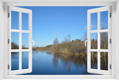 Fototapeta Naklejka Na Ścianę Okno 3D - view to river with reflections and blue cloudy sky