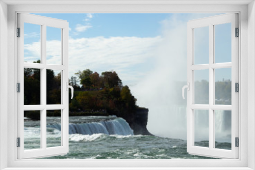 Fototapeta Naklejka Na Ścianę Okno 3D - The famous waterfall of Niagara Falls, a popular place among tourists from all over the world. View from the United States. Falls and buildings.