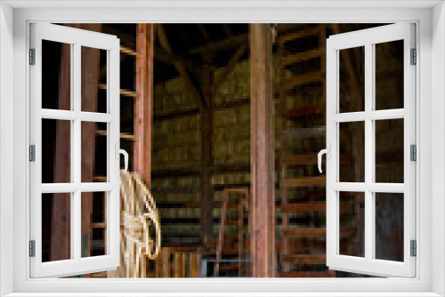 Fototapeta Naklejka Na Ścianę Okno 3D - Barn interior with rope and hay bales.