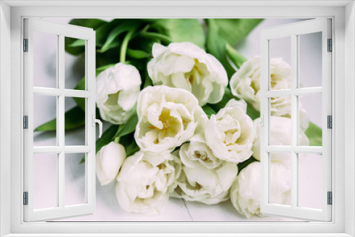 Fototapeta Naklejka Na Ścianę Okno 3D - Bouquet of white tulips on a wooden background with space for text. 
