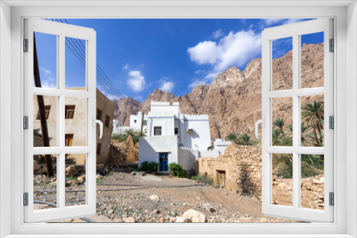 Fototapeta Naklejka Na Ścianę Okno 3D - Typical Oman village surrounded by mountains at Wadi Tiwi - Oman