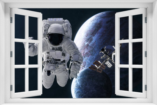 Fototapeta Naklejka Na Ścianę Okno 3D - Astronaut, space station on background of planets in deep space. Science fiction. Elements of this image furnished by NASA