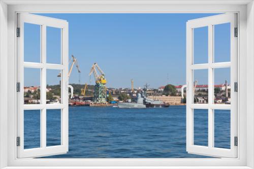 Fototapeta Naklejka Na Ścianę Okno 3D - R-239 missile boat on the background of tower cranes of the Sevastopol Sea Port, Crimea