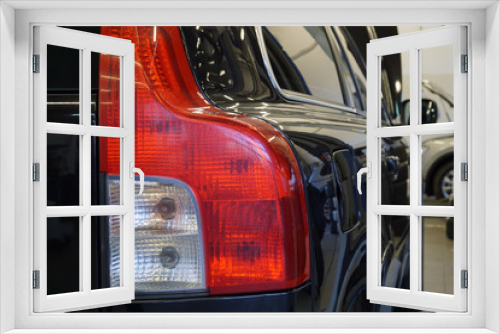 Fototapeta Naklejka Na Ścianę Okno 3D - Closeup of the taillight. Modern luxury black car at the service. Service and repair, spare parts for a modern car. Concept. 