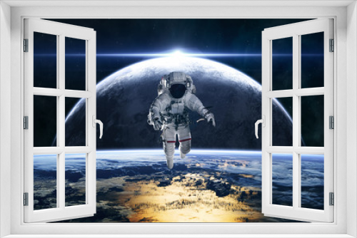 Fototapeta Naklejka Na Ścianę Okno 3D - Astronaut on the background of planets in deep space. Star rise. Science fiction. Elements of this image furnished by NASA