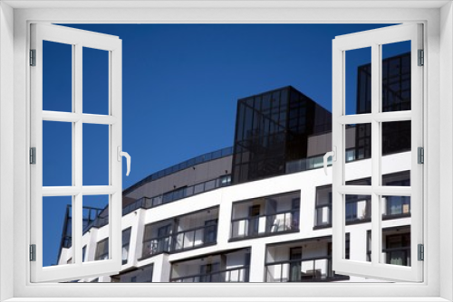 Fototapeta Naklejka Na Ścianę Okno 3D - View of office building  with sunrise, reflection and perspective. Bright outlook for business. Modern office block with sunny beautiful sky.