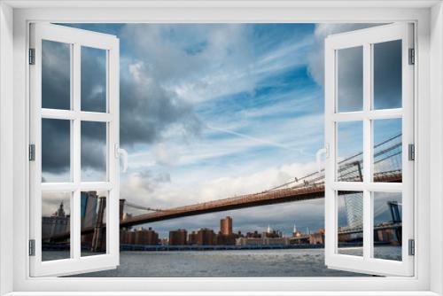 Fototapeta Naklejka Na Ścianę Okno 3D - Scenic view of Brooklyn Bridge crossing to Manhattan at Sunset. Dramatic Sky