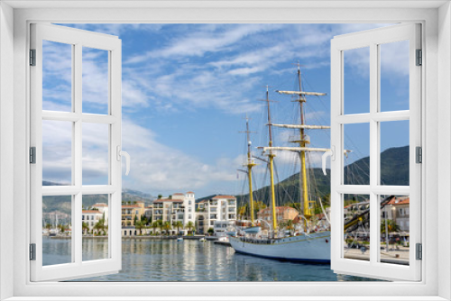 Fototapeta Naklejka Na Ścianę Okno 3D - Montenegro Tivat. Embankment with a view of the mountains, pier and sailboat