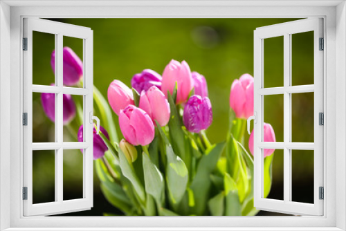 Fototapeta Naklejka Na Ścianę Okno 3D - a bouquet of tulips on a garden table