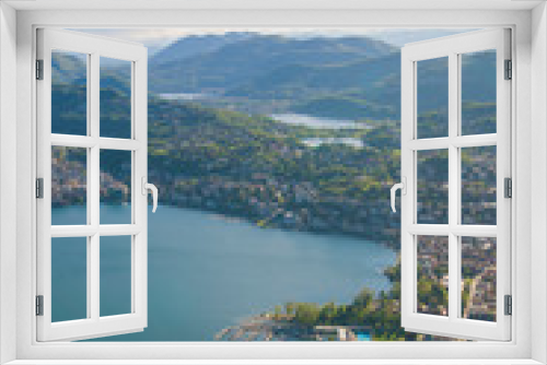 Fototapeta Naklejka Na Ścianę Okno 3D - Top view of the city of Lugano, Switzerland from the height of Mount Monte Bre. Beautiful mountain scenery on a sunny summer day. View of Lake Lugano and the Alpine mountains.