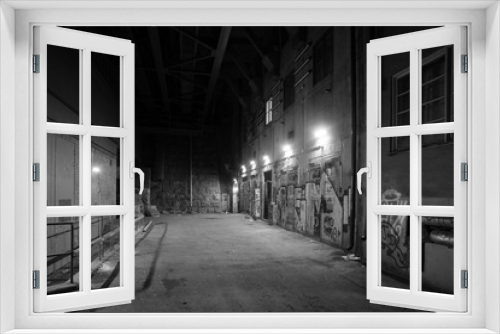 Fototapeta Naklejka Na Ścianę Okno 3D - Depressing dark alley with graffiti in grayscale