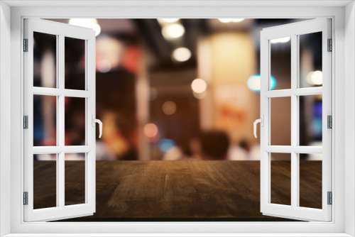 Empty dark wooden table in front of abstract blurred bokeh background of restaurant . can be used for display or montage your products.Mock up for space.