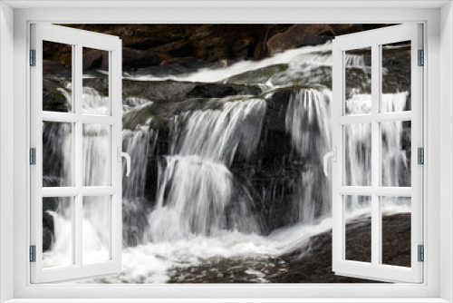 Fototapeta Naklejka Na Ścianę Okno 3D - Long exposure of a waterfall in a rocky landscape