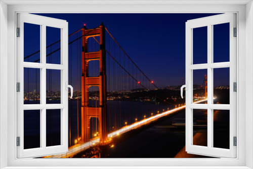 Fototapeta Naklejka Na Ścianę Okno 3D - Golden Gate Bridge and San Francisco skyline at night with passing ocean cargo ship