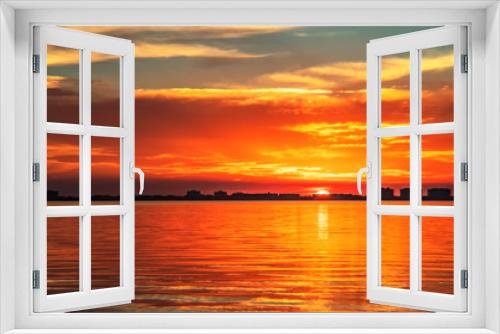 Fototapeta Naklejka Na Ścianę Okno 3D - Indian Beach 6, Sarasota, Florida, beautiful red orange sunset, visible sun, water buildings, skyline, sun-stream , reflection
