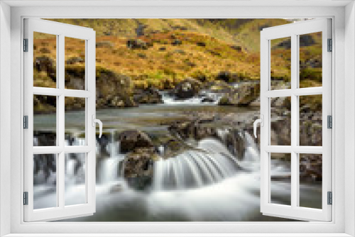 Fototapeta Naklejka Na Ścianę Okno 3D - Small Cascading Waterfall Stream At Deepdale Beck In The Lake District National Park With Snow On Mountain Peaks. 