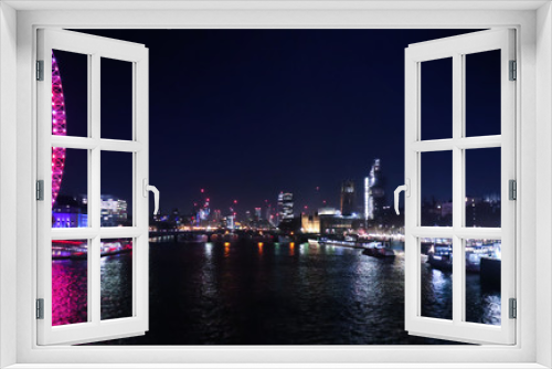 Fototapeta Naklejka Na Ścianę Okno 3D - View of Westminister and South Bank in London during evening hours.  Neon lights are reflecting in the water. Thames water in the middle.