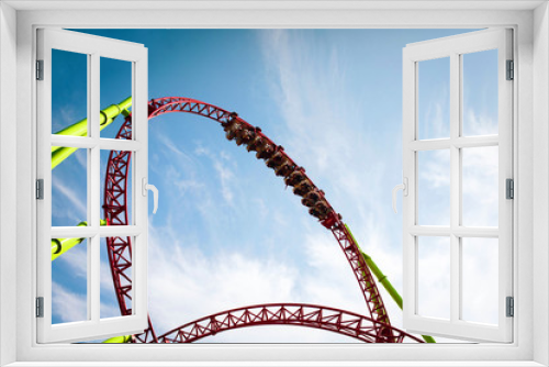 Fototapeta Naklejka Na Ścianę Okno 3D - Rollercoaster large loops in an amusement park. Summer panorama. Copy space.