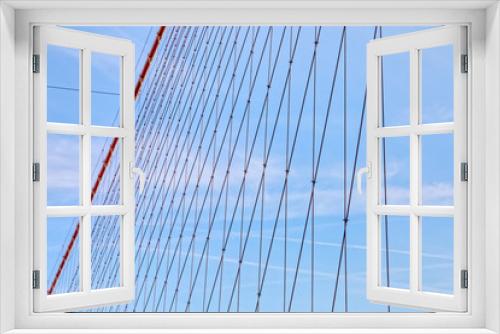 Fototapeta Naklejka Na Ścianę Okno 3D - Brooklyn Bridge cable net against blue sky, New York