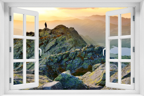 Fototapeta Naklejka Na Ścianę Okno 3D - Banner, web page or cover template of Man on the top of the hill watching wonderful scenery in mountains during summer colorful sunset in High Tatras in Slovakia. Copy space and panoramic ratio
