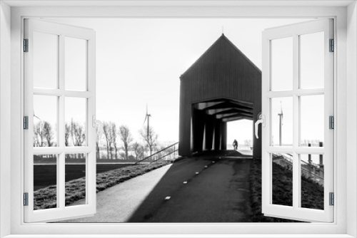 Fototapeta Naklejka Na Ścianę Okno 3D - Cyclist entering the Engelandvaardersviaduct in Rotterdam / Hoek van Holland