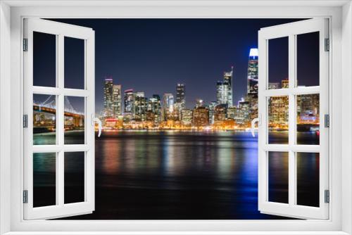 Fototapeta Naklejka Na Ścianę Okno 3D - Nighttime view of San Francisco city. Calm and peaceful conditions in the bay as the city light illuminate the water. 