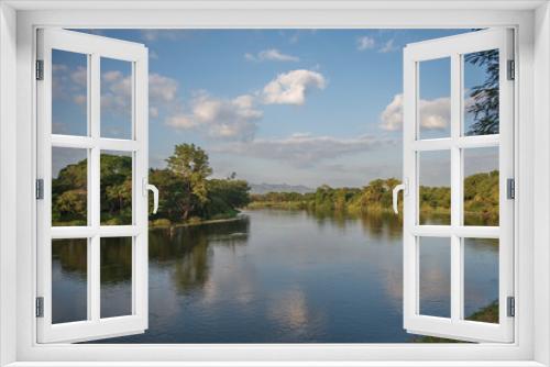 Fototapeta Naklejka Na Ścianę Okno 3D - River view surrounded by green trees