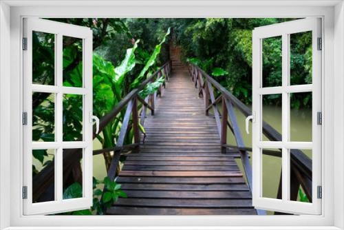 Fototapeta Naklejka Na Ścianę Okno 3D - A small wooden bridge over a small river in a rainforest in Madagascar