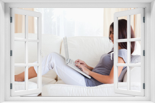 charming woman on sofa with notebook