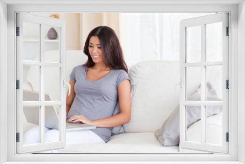 smiling woman on sofa with notebook