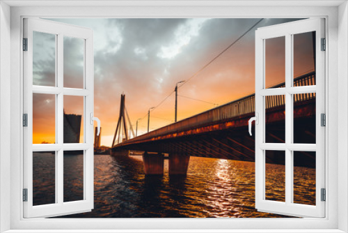 Fototapeta Naklejka Na Ścianę Okno 3D - Vansu bridge in Riga cable-stayed bridge  crosses the Daugava river in susnet time