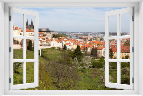 Fototapeta Naklejka Na Ścianę Okno 3D - Spring Prague City with gothic Castle and the green Nature and flowering Trees from the Hill Petrin, Czech Republic