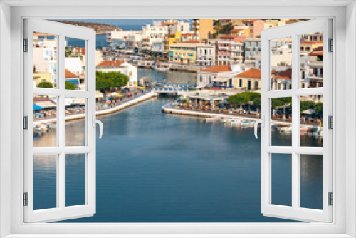 Fototapeta Naklejka Na Ścianę Okno 3D - top view of a quiet bay and the Greek resort town of Agios Nikolaos on a sunny summer day