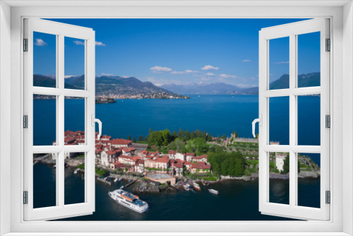 Fototapeta Naklejka Na Ścianę Okno 3D - Isola Bella is located on Lake Maggiore in Italy. Magnificent garden Borromee in the background the alps in the snow, clouds in the blue sky. The ship is sailing to the island