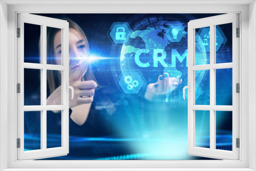 Business, Technology, Internet and network concept. Young businessman working on a virtual screen of the future and sees the inscription: CRM