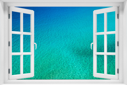 Fototapeta Naklejka Na Ścianę Okno 3D - Sea surface aerial view. Background image of the turquoise sea. Deep sea and corals. Aerial drone shot of turquoise water, space for text. Aquamarine background. Sea Aerial view.