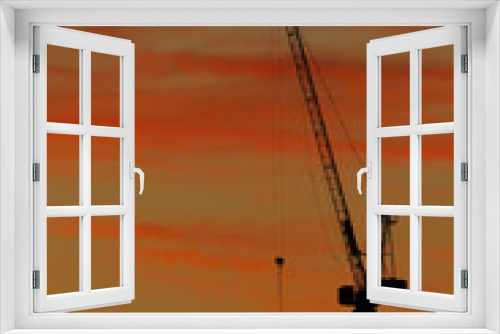 Fototapeta Naklejka Na Ścianę Okno 3D - Silhouettes of construction cranes and beautiful sky background.