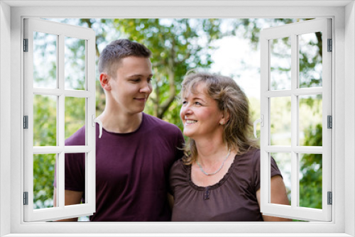 Cheerful mother with adult son outdoors. Family concept.