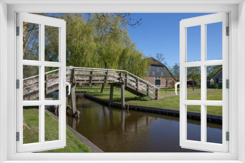 Fototapeta Naklejka Na Ścianę Okno 3D - Giethoorn Overijssel Netherlands. During Corona lock-down. Empty streets, paths, bridges and canals.