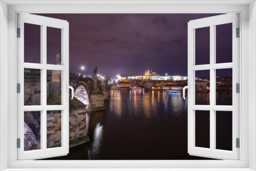 night landscape on Charles bridge in Prague, sculptures and the old town