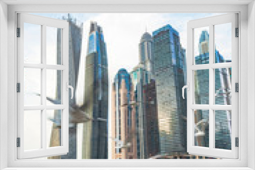 Fototapeta Naklejka Na Ścianę Okno 3D - Seagulls flying. Modern Arab style architecture buildings in Marina Dubai. Exclusive neighborhood, residence, coportarivo and tourist. Rich lifestyle. Yachts in the water. Real estate business